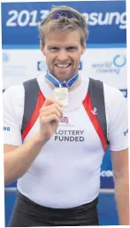  ??  ?? Alan with silver medal he won in men’s single sculls final at the 2013 Samsung World Rowing Cup II