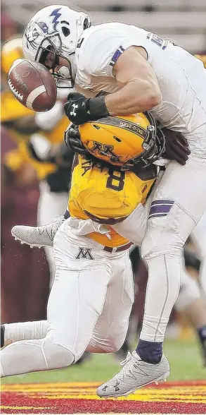  ?? | STACY BENGS/ AP ?? Northweste­rn wide receiver Flynn Nagel can’t hold on to the ball after being hit by Minnesota defensive back Duke McGhee on Saturday in Minneapoli­s.