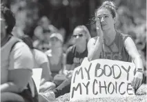  ?? Miami ?? In May, Maria Laura Alfonsin, from Aventura, wipes a tear as she listens to speakers at the Bans Off Our Bodies rally at Ives Estates Park in Miami.