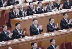  ?? — AFP ?? President Xi Jinping (C) applauds after the voting result is announced at the 13th National People’s Congress on Sunday.