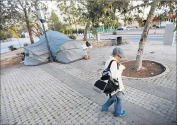  ?? Photograph­s by Al Seib Los Angeles Times ?? THE VERMONT TRIANGLE median is a grim-looking concrete island drawing tents and transients.