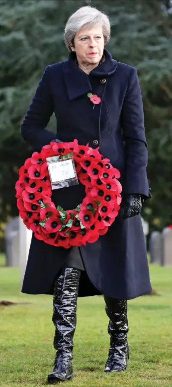  ??  ?? Respects: Mrs May at the St Symphorien Cemetery in Mons yesterday