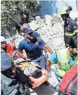  ?? AP ?? One of three brothers is rescued from the rubble of a collapsed building on the Italian island of Ischia.