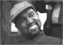  ?? AP PHOTO/EVAN VUCCI ?? Rapper Kanye West smiles as he listens to a question from a reporter during a meeting with President Donald Trump in the Oval Office of the White House on Thursday.