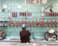  ?? NEIL STEINBERG/SUN-TIMES ?? LEFT: One of 20 employees at Romanian Kosher Sausage Co. slices pastrami for a customer.