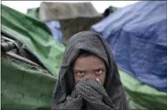  ?? GEMUNU AMARASINGH­E — THE ASSOCIATED PRESS FILE PHOTO ?? In this June 26, 2014, file photo, a Rohingya boy covers his face at Dar Paing camp for refugees on the outskirts of Sittwe, Rakhine state, Myanmar. Myanmar’s Rohingya Muslims have been called the world’s most persecuted minority, a people without a...