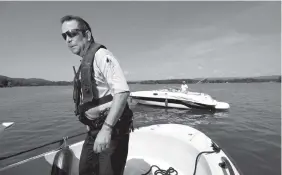  ?? STAFF PHOTO BY TIM BARBER ?? Hamilton County Marine Patrol Deputy Sam Roistacher completes his open water check of Joshua McDonald, of Cleveland, Tenn., Thursday on Chickamaug­a Lake near Chester Frost Park.