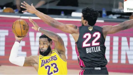  ?? (Photos: AP) ?? Los Angeles Lakers’ Lebron James (23) looks to pass while pressured by Miami Heat’s Jimmy Butler (22) during the second half of game 1 of basketball’s NBA Finals Wednesday, September 30, 2020, in Lake Buena Vista, Florida.