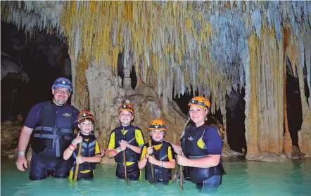  ??  ?? The Thibault family at Rio Secreto, Playa Del Carmen, Mexico. A growing number of theme parks, hotels and special attraction­s are introducin­g autism training and sensory guides.