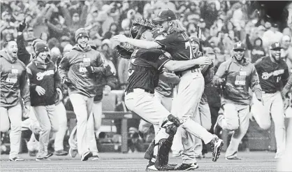  ?? JOHN LEYBA THE ASSOCIATED PRESS ?? Milwaukee reliever Josh Hader, front right, jumps on catcher Erik Kratz after getting Colorado Rockies’ Ian Desmond for the final out in a 6-0 win Sunday in Denver. The Brewers advance to the National League Championsh­ip Series against the Los Angeles Dodgers.