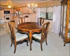  ??  ?? The dining room opens into the living room area in the home at 209 Duquesne Ave. in Trafford.