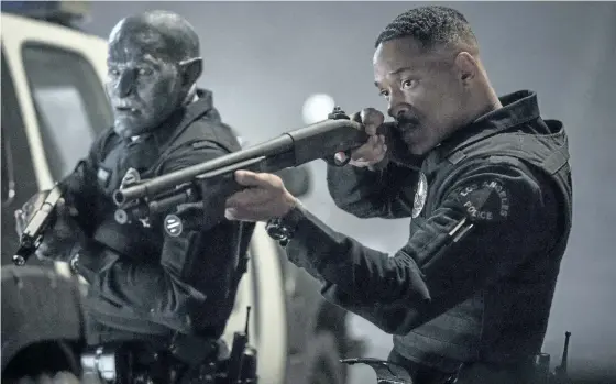  ?? THE ASSOCIATED PRESS ?? Will Smith, right, and Joel Edgerton are seen in a scene from Bright, a buddy cop movie about a human cop, Will Smith, teaming up with the first orc cop in an alternate-reality South Central Los Angeles.