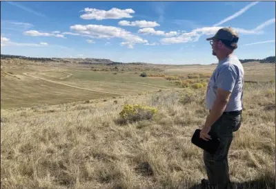  ?? (Paul Hamby/The Billings Gazette via AP) ?? Jarrod Burks, an archaeolog­ist with expertise in geophysics, stands on a hillside with the marks of a magnetomet­er visible in the surroundin­g grassland at Rosebud Battlefiel­d State Park, on Aug. 30, 2015, near Busby, Mont. Burks is part of a team looking for graves from the 1876 battle.