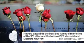  ?? CHIP SOMODEVILL­A/ GETTY ?? Flowers placed into the inscribed names of the victims of the 9/11 attacks at the National 9/11 Memorial and Museum, New York