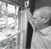  ?? TONY DEJAK/AP ?? Matt Moorhead looks out his window on March 2 in Warren, Ohio. Moorhead went by himself in 2019 to Lansing, Michigan, but quit to move back with his family.