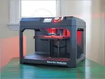  ??  ?? FOR THE TEST, the writer used this MakerBot Replicator. The 3-D printer sits on the kitchen table, ready for action.