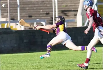  ??  ?? An airborne Ryan Mahon gets his shot away as Shane Bannon of Galway looks on.