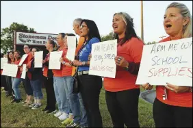  ?? AP PHOTO ?? Marjory Stoneman Douglas teachers demonstrat­e in front of the school in Parkland, Fla., on Friday.