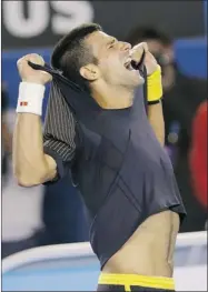  ?? DATA ALANGKARA/ ASSOCIATED PRESS ?? Novak Djokovic rips his shirt off as he celebrates his fourthroun­d win over Stanislas Wawrinka in a five-hour match at the Australian Open on Sunday.