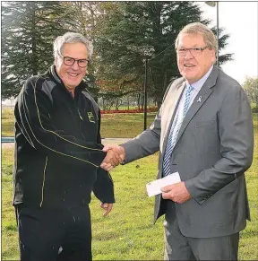  ??  ?? CAMBRIDGE Lions member Peter Knox hands Waipa¯ Mayor Jim Mylchreest a cheque for $50,000 at yesterday’s site Cambridge pool site blessing.