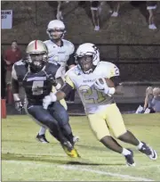  ??  ?? Top: Morgan Sims ran into a wall of Pepperell defenders most of the night on Oct. 14. Above: D’Lante McClain also found himself struggling to find gaps within the Pepperell defensive line, who played tough through four quarters.