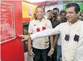  ??  ?? Transport and Civil Aviation Deputy Minister Ashok Abeysinghe opens the ceremonial plaque of People’s Bank 200th Self-banking Unit
