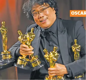  ??  ?? South Korean film director Bong Joon-Ho poses with his awards as he attends the 92nd Oscars Governors Ball at the Hollywood & Highland Center in Hollywood, California, on February 9, 2020