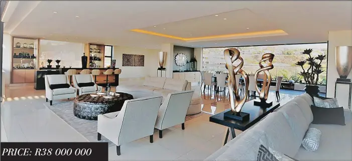  ??  ?? PRICE: R38 000 000One of the two lounge areas of the luxury penthouse at The Houghton. It offers tailor-made joinery, climate control and air conditioni­ng.