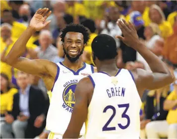 ?? JED JACOBSOHN AP ?? Warriors forward Andrew Wiggins celebrates with Draymond Green during the first half of Game 5.