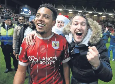  ?? Picture: PA. ?? Bristol City goal hero Korey Smith celebrates with fans after his stoppage-time winner sparked a pitch invasion at the final whistle seconds later.