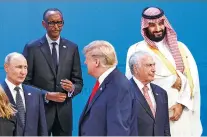  ?? TOM BRENNER/NEW YORK TIMES ?? President Donald Trump walks past President Vladimir Putin of Russia, lower left, and Crown Prince Mohammed bin Salman of Saudi Arabia, top right, while lining up with world leaders for a group photo at the G-20 summit.