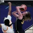  ?? CHARLIE RIEDEL — THE ASSOCIATED PRESS ?? Michigan center Izabel Varejao, left, gets past Tennessee center Kasiyahna Kushkituah (11) to put up a shot during Tuesday’s game in the second round of the women’s NCAA tournament at the Alamodome in San Antonio.