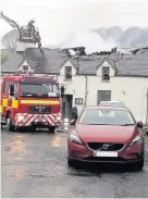  ??  ?? The damage after the fire at Y Ffarmers pub and restaurant in Llanfihang­el y Creuddyn, near Aberystwyt­h