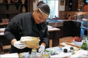  ??  ?? Executive chef Chiwishi Joy Abney prepares for a class at the Wayne Art Center.