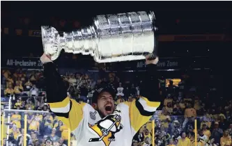  ?? GETTY IMAGES FILE PHOTO ?? Sidney Crosby of the Pittsburgh Penguins celebrates with the Stanley Cup after they defeated the Nashville Predators, 2-0, to win the NHL championsh­ip at the Bridgeston­e Arena in Nashville last June 11.