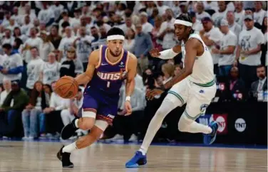  ?? Associated Press ?? Phoenix Suns guard Devin Booker (left) drives against Minnesota Timberwolv­es’ Jaden Mcdaniels during their game two of first-round of playoff series on Tuesday.