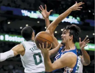  ??  ?? Sixers forward Dario Saric (9) goes up to shoot against Celtics forward Jayson Tatum (0) in the first quarter Thursday.