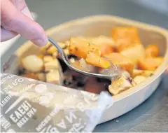  ??  ?? A chef stirs a Stouffers Kentucky Bourbon glazed chicken meal at the Nestle Developmen­t Centre.