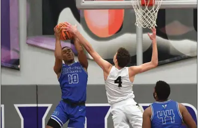  ?? (NWA Democrat-Gazette/J.T. Wampler) ?? Camren Hunter of Bryant pulls a rebound away from Bentonvill­e’s Caden Miller during Thursday’s game at the Class 6A boys state tournament at Fayettevil­le.