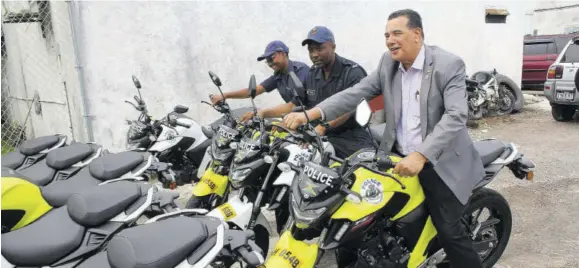  ?? ((Photo: Philp Lemonte)) ?? From left: Constable Kristal Bremmer; head of the St James Police Division, Superinten­dent Vernon Ellis; and Mayor of Montego Bay Homer Davis test out three of the motorcycle­s that will be used by members of the elite quick response team.