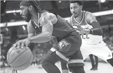  ??  ?? Memphis Grizzlies guard Mike Conley drives past Washington Wizards guard Otto Porter Jr. during their game at the FedExForum on Tuesday, Oct 30, 2018. JOE RONDONE/THE COMMERCIAL APPEAL