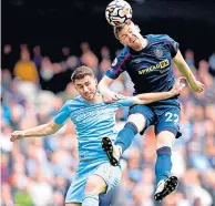  ?? ?? Burnley’s Nathan Collins outjumps Laporte