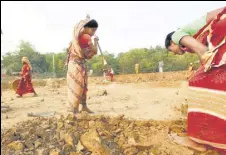  ?? REUTERS FILE ?? Women work at a constructi­on site under MGNREGS.