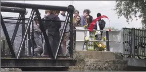  ??  ?? Tributes: Friends and well-wishers at the canal bridge yesterday