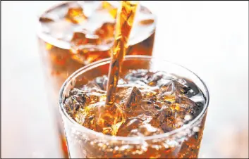  ?? Getty Images ?? People with arthritis should limit consumptio­n of soda and other sugary drinks.