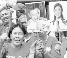  ??  ?? File photo shows ‘Red Shirt’ demonstrat­ors, supporters of Thaksin (pictured second right), shouting slogans as they gather in support ofYingluck (pictured right),after she was endorsed into office at parliament in Bangkok. — AFP photo