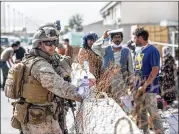  ?? SGT. SAMUEL RUIZ/U.S. MARINES VIA AP ?? U.S. Marines provide assistance during ongoing attempts to evacuate U.S. personnel, allies and Afghans who worked for the Americans.