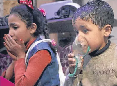  ?? Picture: Getty. ?? Syrian children receive medical treatment after the alleged attack on Douma.