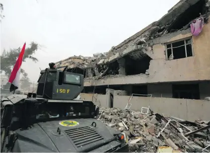  ?? Ahmed Saad / Reuters ?? A member of the Iraq Special Operations Forces watches the rooftops at the Mosul university during the battle with ISIL.