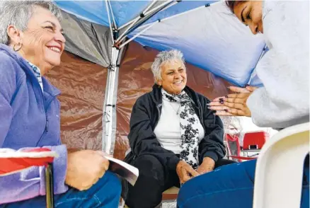  ?? PHOTOS BY ERIC PAUL ZAMORA/FRESNO BEE/TRIBUNE NEWS SERVICE ?? Chasity Barajas, right, was amazed when she felt her hands rising as the three women, Linda Crowder, left, and Virginia La Salle, center, prayed together in Fresno, Calif.